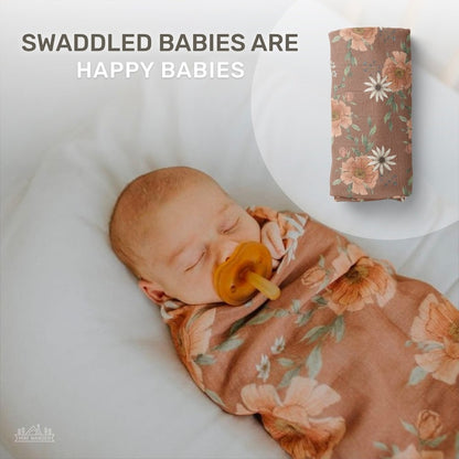 infographic showing swaddled babies are happy babies with a background of the rolled floral muslin swaddle and a sleeping baby wrapped in this clay brown peony blooms swaddle blanket