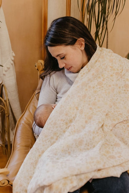 mom and baby breastfeeding using muslin swaddles in natural cotton as breastfeeding cover