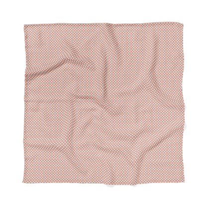 blush pink polka dot swaddle blanket laid flat 
