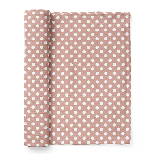 half-rolled polka dot pink swaddle blanket