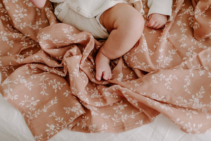 photo of a baby with chubby legs lying down on a Bloom sianna mini wander swaddle