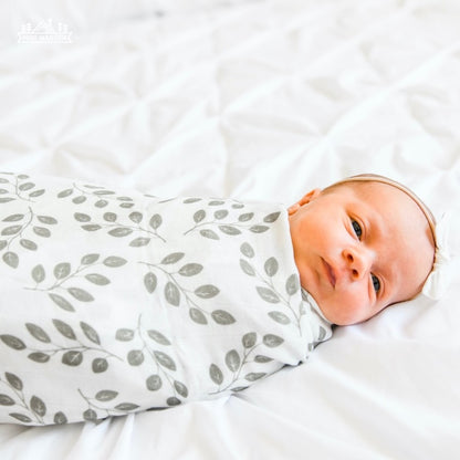 sweet baby girl wrapped like a burrito in her summer swaddle the perfect muslin cotton swaddle for swaddling in the summer