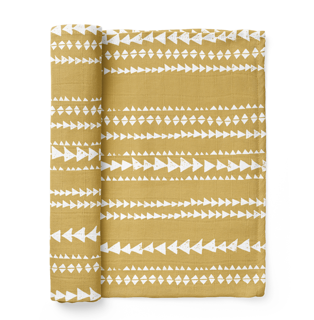 photo of the terrain muslin swaddle wrap in color mustard yellow showing the dusty yellow aztec pattern