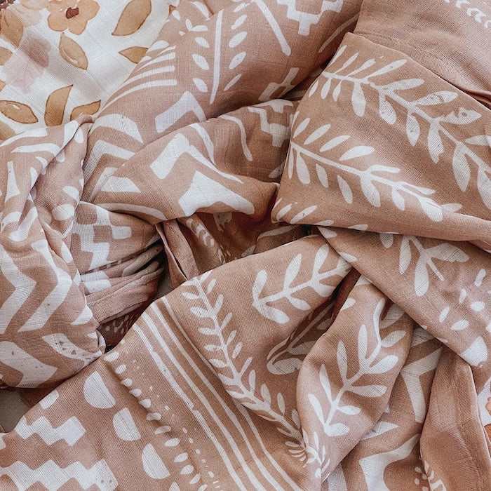 dusty pink swaddle up close showing the textured lines and boho patterns