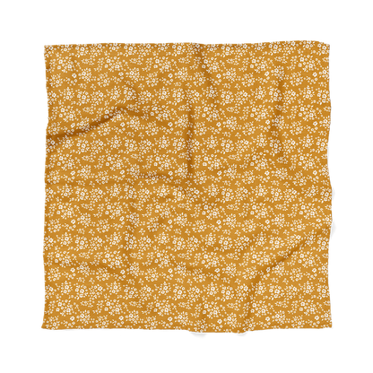 A full view of Mini Wander rich yellow with white floral pattern baby swaddle wrap