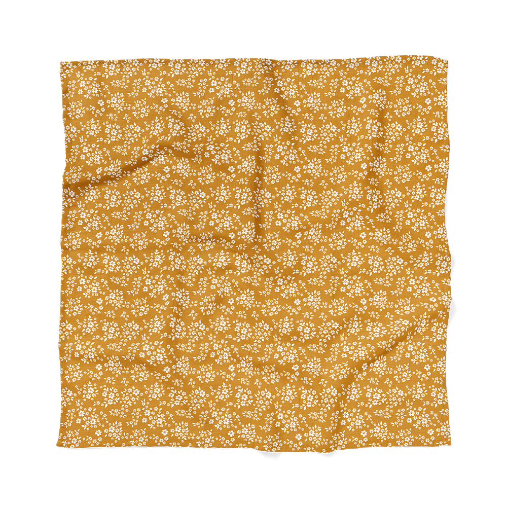 whimsy floral swaddle blanket one of the baby gift set for girls laid flat showing the mustard color and the pretty petals