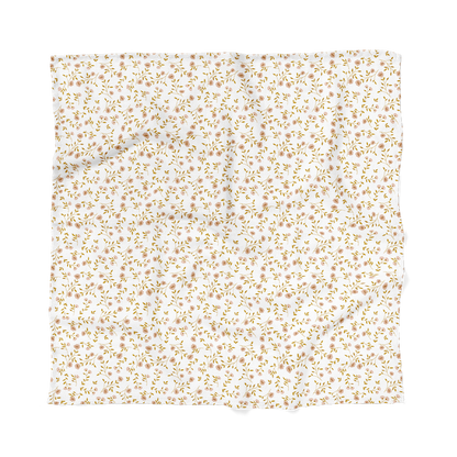 The Mini Wander wildflower white floral baby blanket laid flat showing the wildflowers pink pattern and tiny leaves