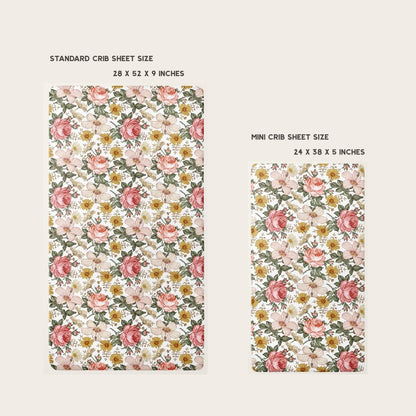 two crib sheets laid flat side by side from each other comparing the size and measurements of the standard and mini size floral crib sheets