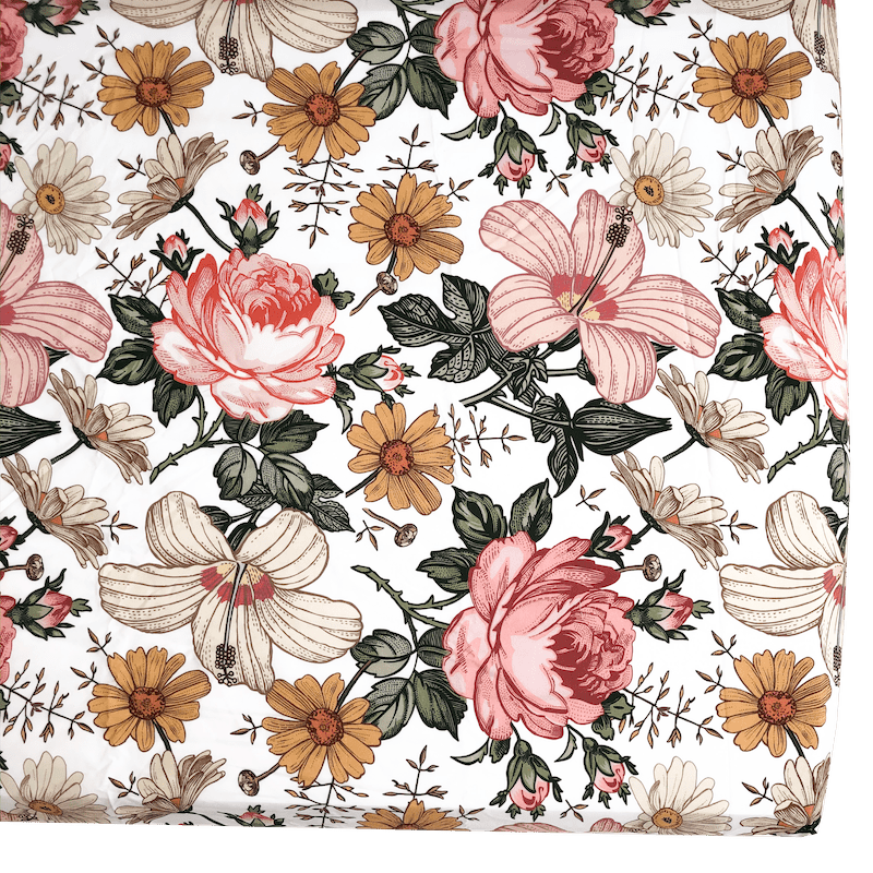corner image of the vintage floral crib sheet displaying the exquisite and decorative flowers such as hibiscus blossoms, white and yellow daisies and red roses