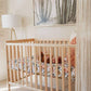a light and airy baby nursery unveiling the bold and beautiful vintage floral crib sheet inside the crib with an adorable little baby lying on her back